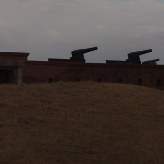 silhouettes of 4 cannons at fort clinch, north east florida